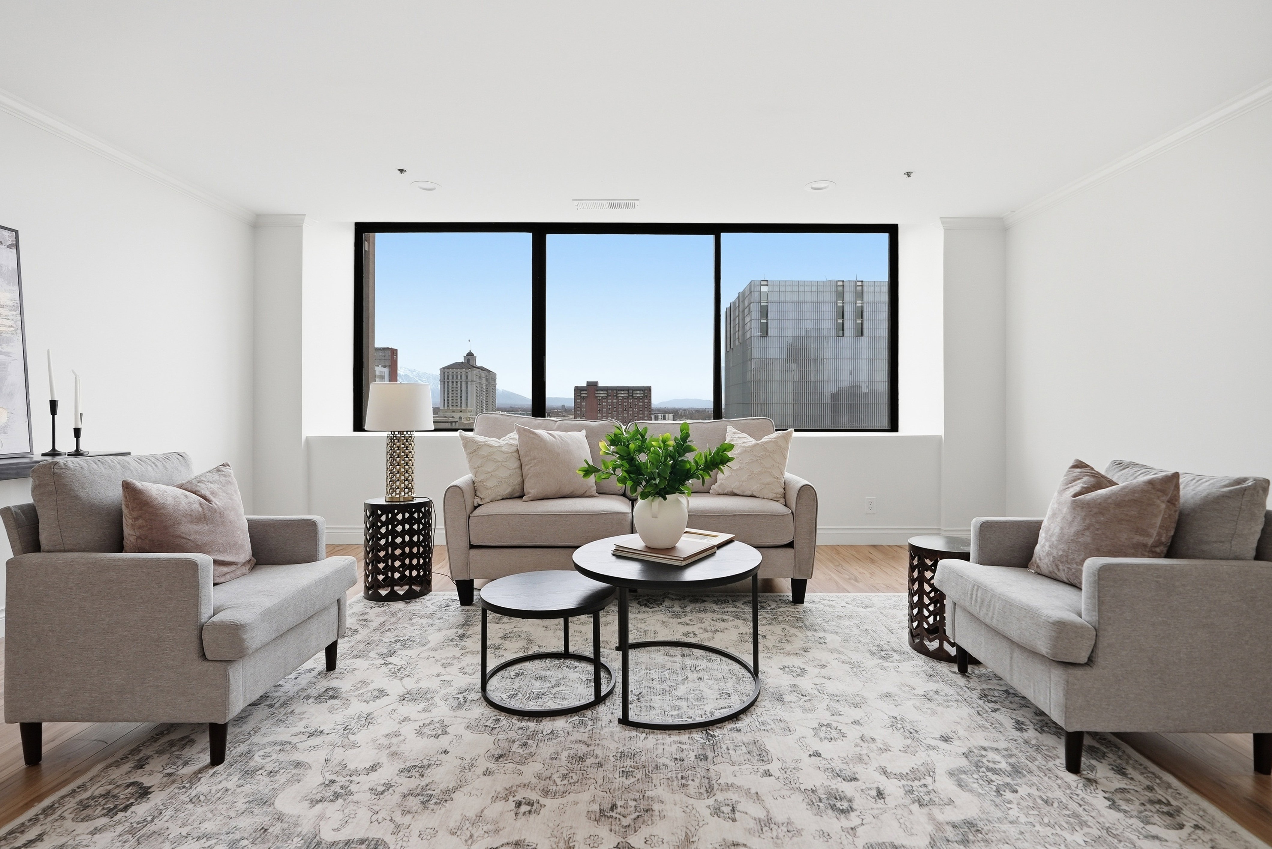 Living room with ornamental molding, light wood-type flooring, and healthy amount of natural light