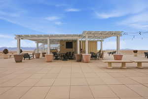 View of patio with a mountain view, a pergola, and outdoor dining area