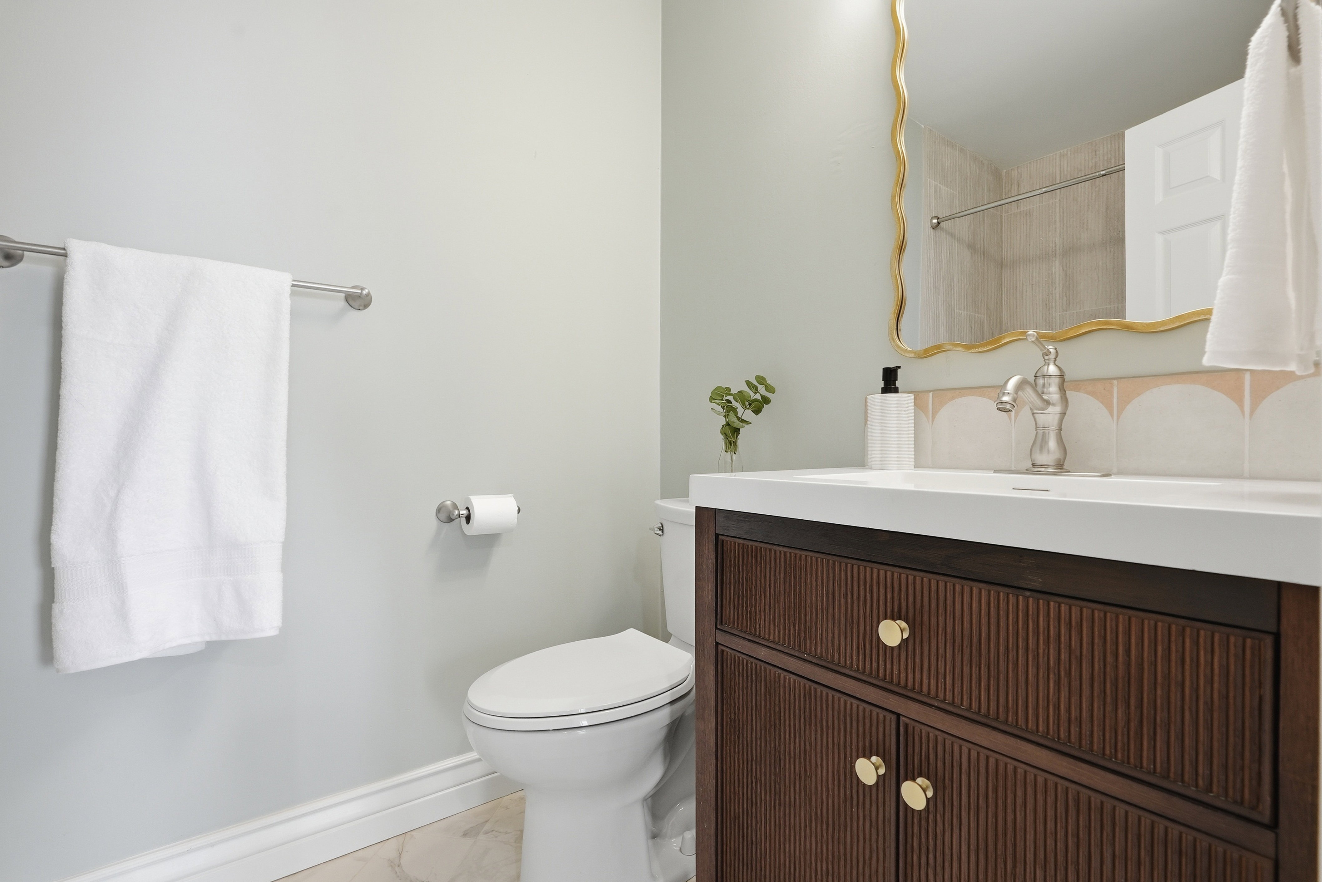 Full bath featuring vanity, curtained shower, and light marble finish flooring