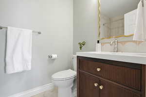 Full bath featuring vanity, curtained shower, and light marble finish flooring