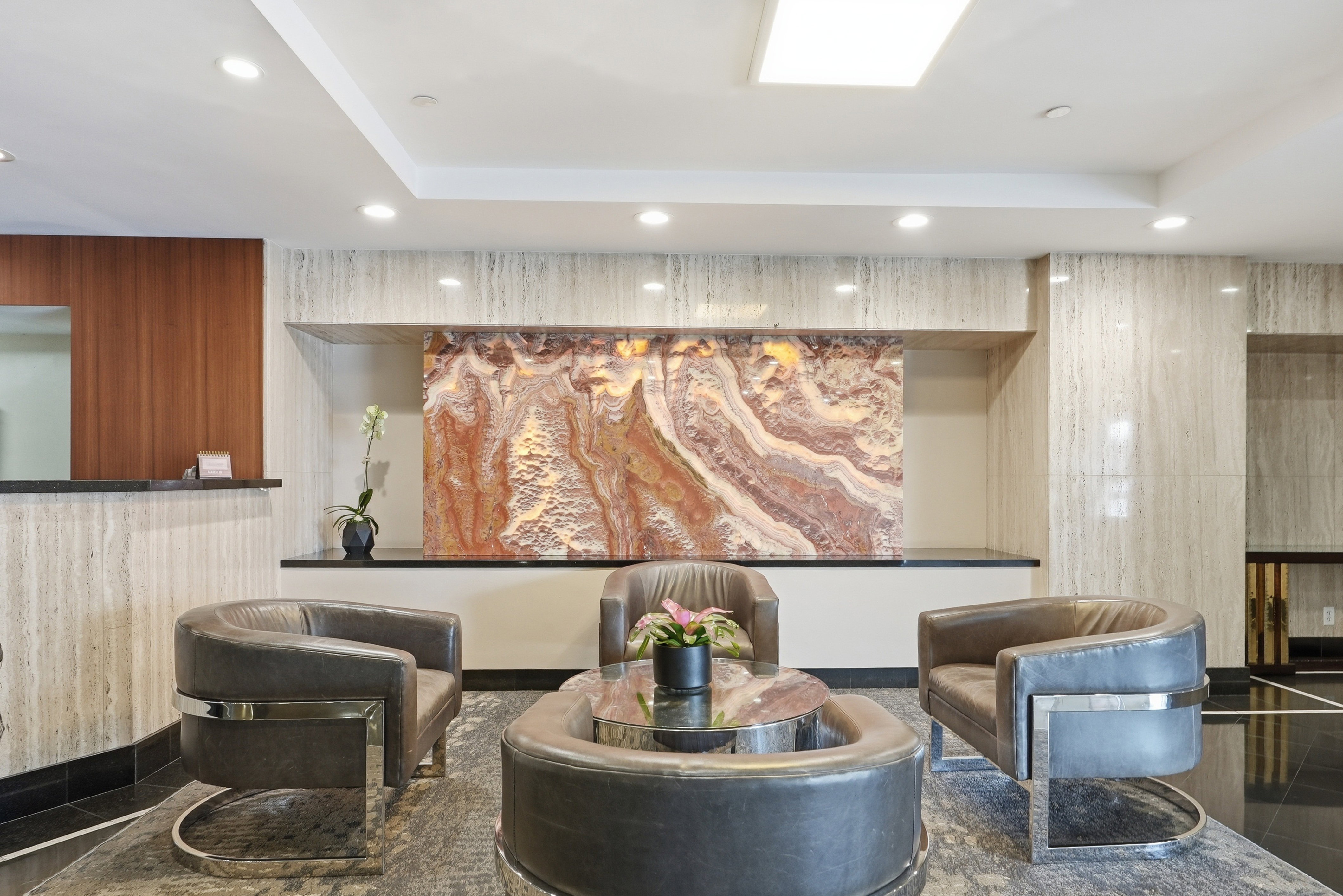 Building lobby with recessed lighting and a raised ceiling