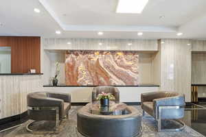 Building lobby with recessed lighting and a raised ceiling