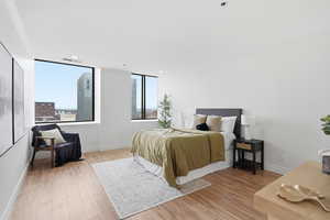 Bedroom featuring crown molding and light wood finished floors