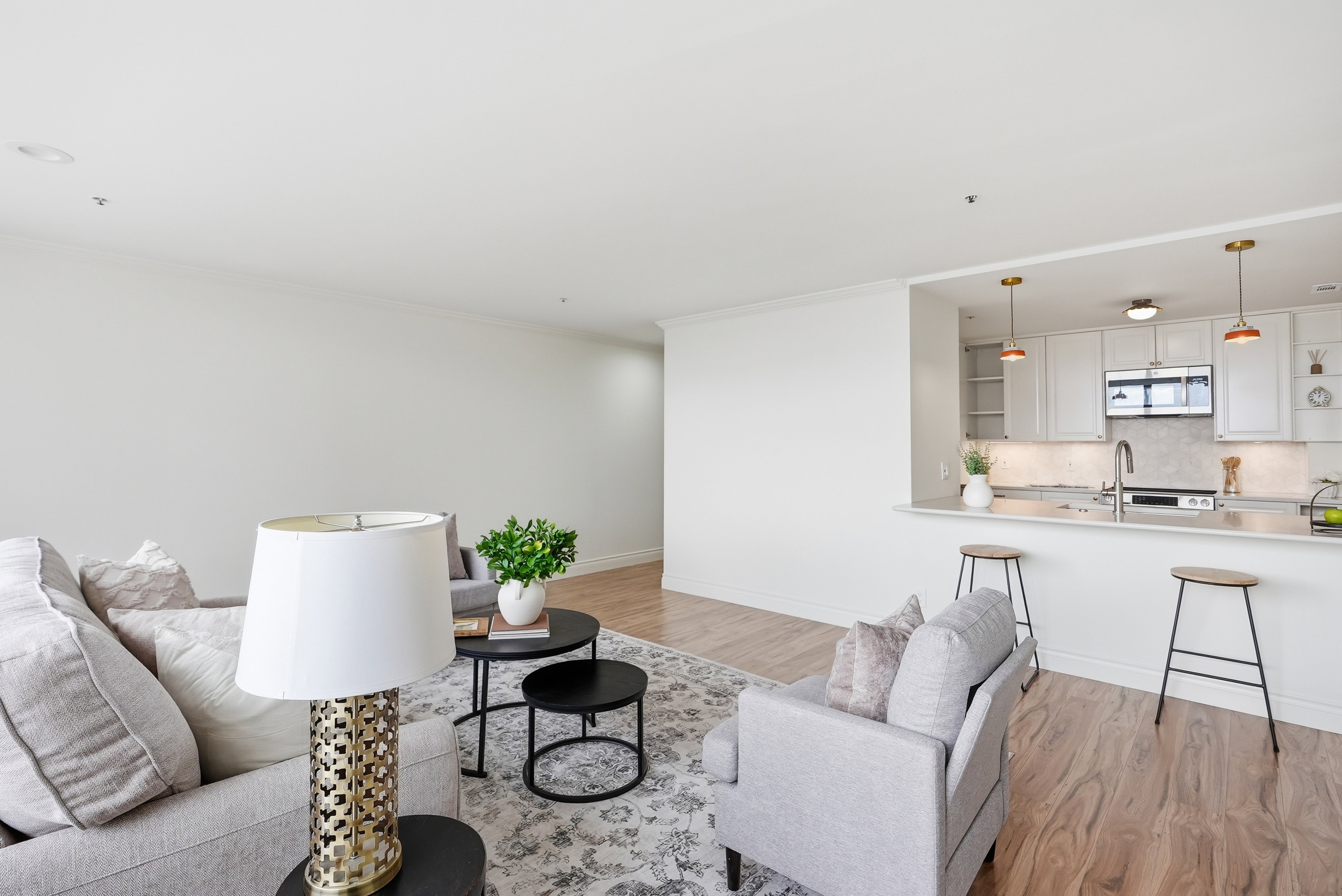 Living area with light wood-type flooring and crown molding