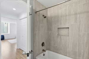 Full bath featuring bathtub / shower combination and light wood-style floors