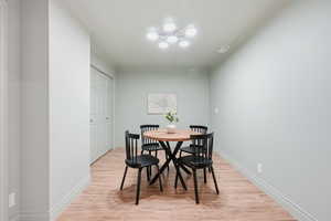 Dining room with light wood finished floors and crown molding