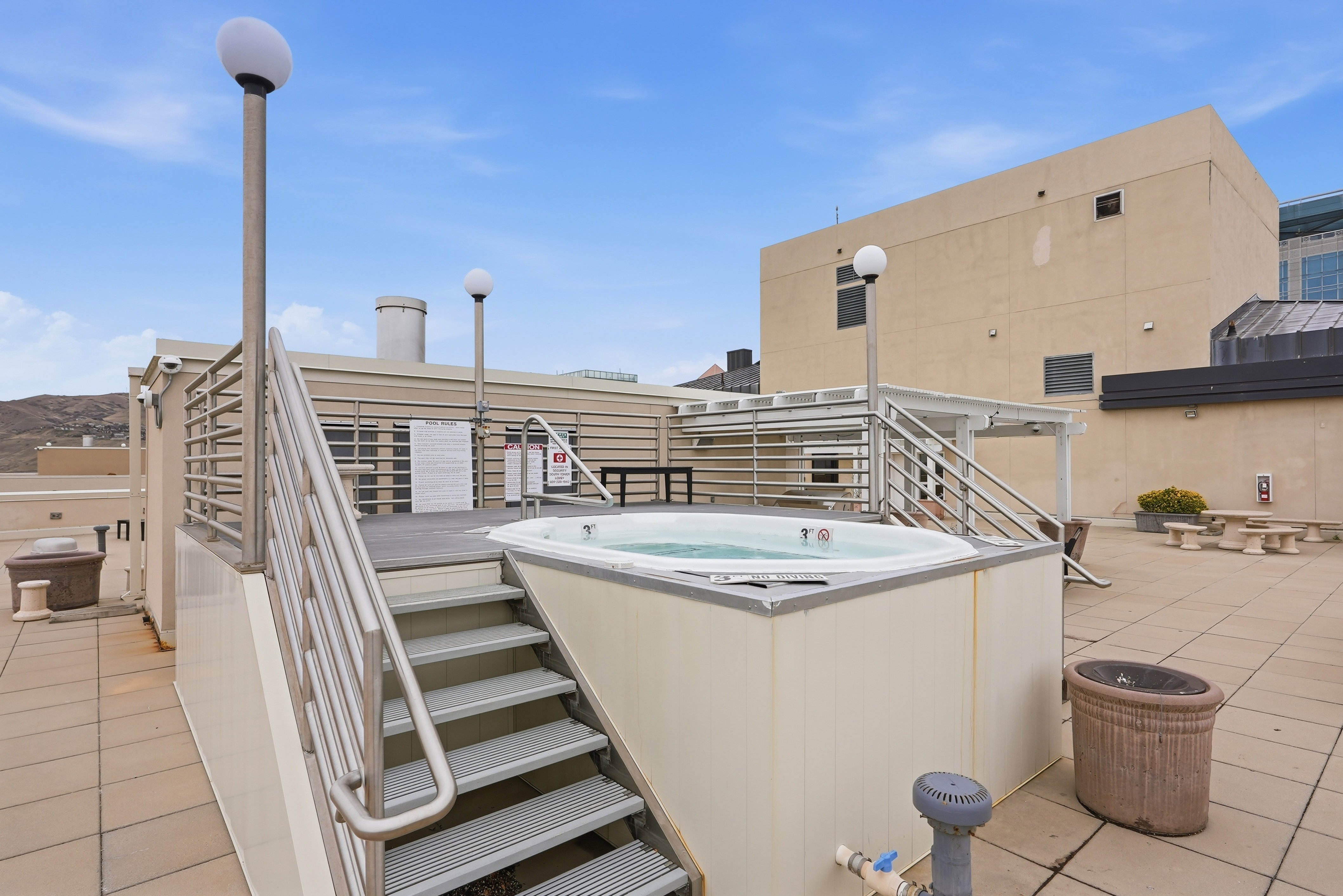 View of patio with a hot tub
