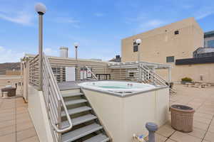 View of patio with a hot tub