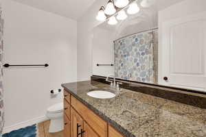 Bathroom featuring vanity, a shower with curtain, and light tile patterned floors