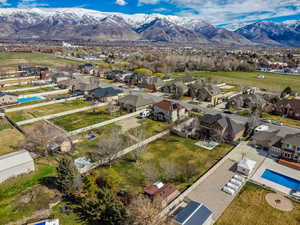 Aerial perspective of suburban area with a pool area and mountains