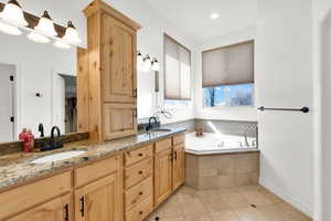 Full bathroom with double vanity, light tile patterned floors, a bath, and recessed lighting