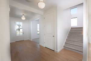 Entrance foyer with plenty of natural light and light wood-type flooring