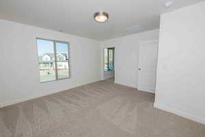 Unfurnished room featuring carpet floors and baseboards