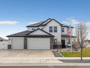 Craftsman-style home with covered porch, concrete driveway, an attached garage, a shingled roof, and a gate