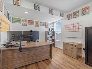 Home office featuring light wood finished floors and recessed lighting