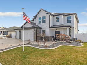 Back of property featuring an attached garage, driveway, a gate, and a porch