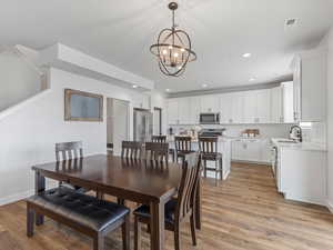 Dining area featuring a chandelier and light wood finished floors