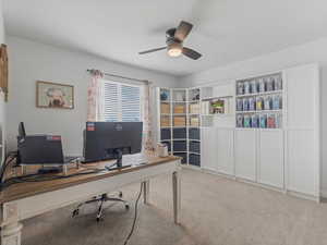Office space with light carpet and a ceiling fan