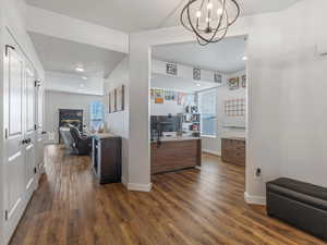 Office area featuring dark wood-style flooring and hanging lights