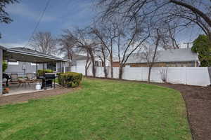 Fenced backyard with a patio