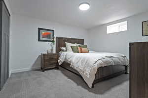 Bedroom with light carpet and baseboards