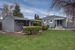 Back of house featuring a shingled roof
