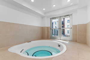 View of pool featuring an in-ground hot tub