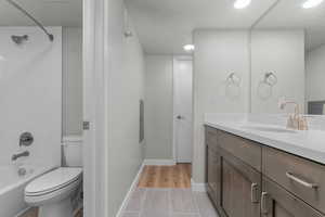 Bathroom featuring vanity, shower / bathtub combination, a textured ceiling, and electric panel