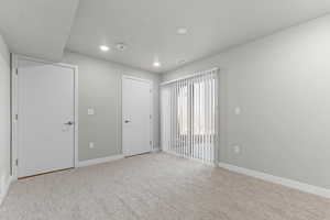 Unfurnished bedroom with light colored carpet, recessed lighting, and a textured ceiling
