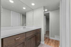 Bathroom with vanity and recessed lighting