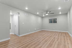 Spare room with light wood-style flooring, ceiling fan, and recessed lighting