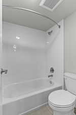 Full bath with shower / bathtub combination and light tile patterned floors