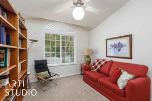 Sitting room with light carpet, ceiling fan, and lofted ceiling (guest bedroom)