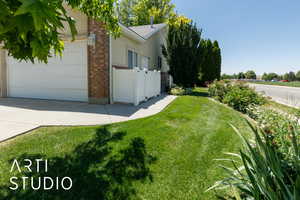 View of yard with a garage and concrete driveway