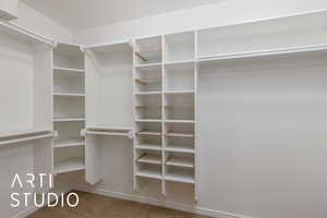 Master Bedroom Walk in closet featuring light carpet