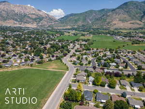 Aerial overview of property's location featuring mountains and nearby suburban area