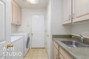 Laundry room featuring cabinet space and washer and clothes dryer
