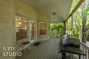 Covered deck featuring grilling area
