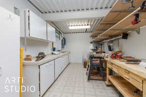 Workshop showing countertops, white cabinets, and light floors