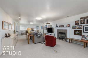 Family room featuring light colored carpet and fireplace