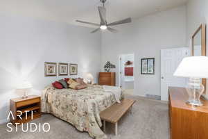 Master Bedroom featuring a high ceiling, light carpet, a ceiling fan, and ensuite bathroom