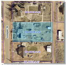 Aerial map of property and surrounding area featuring property boundaries highlighted