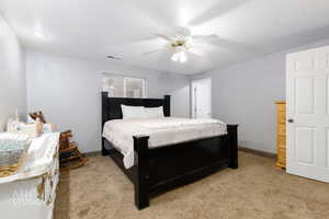 Bedroom featuring light colored carpet and ceiling fan