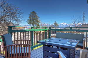 Wooden deck with a mountain view and outdoor dining area