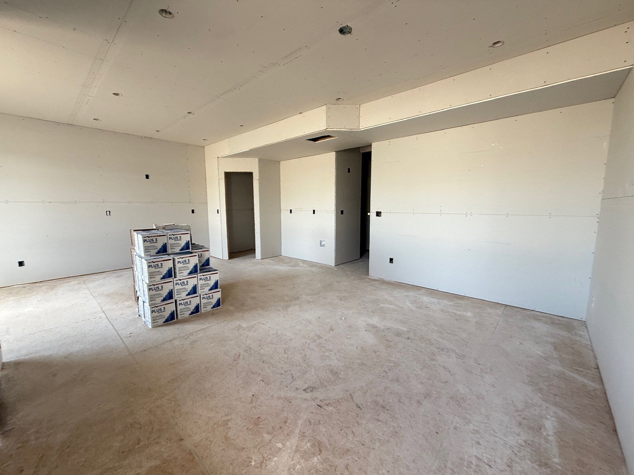 Spare room featuring unfinished concrete floors