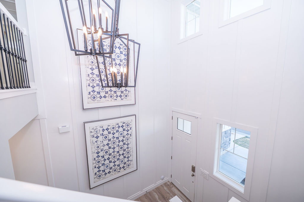 Entrance foyer featuring suspended lighting and wood finished floors