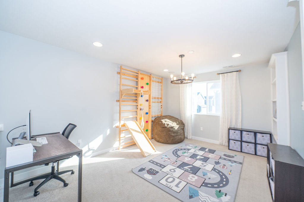 Home office featuring a chandelier and light colored carpet