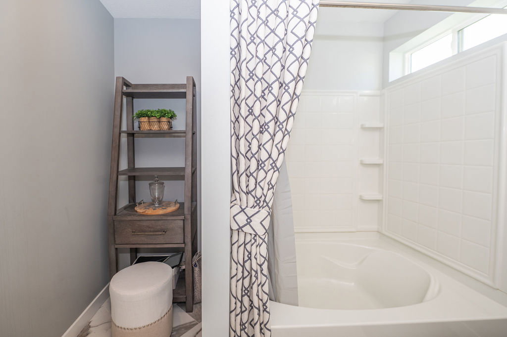 Full bath with baseboards and shower / bathtub combination with curtain