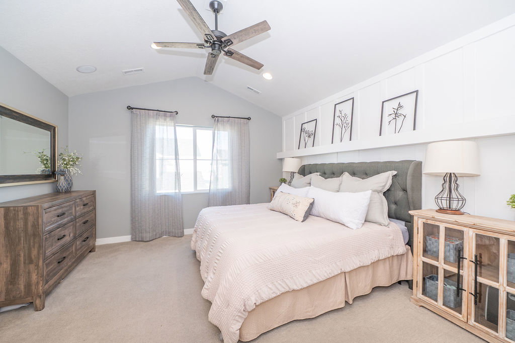 Bedroom with light colored carpet, ceiling fan, and recessed lighting