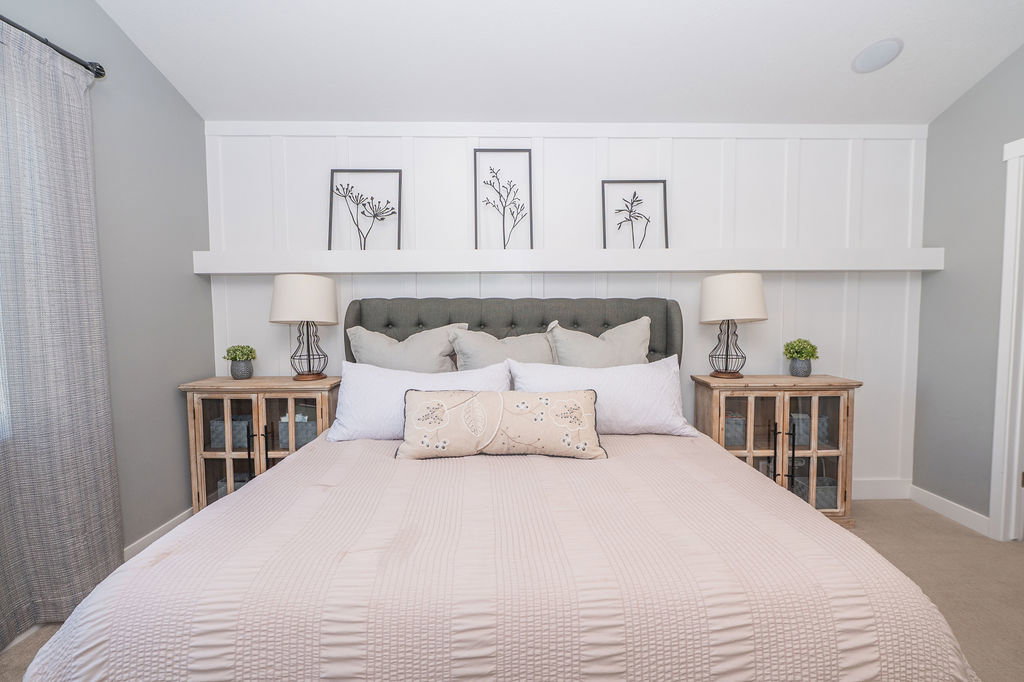 Bedroom with carpet floors and vaulted ceiling